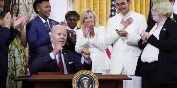 President Joe Biden celebrates after signing an executive order at an event to celebrate Pride Month in the East Room of the White House, Wednesday, June 15, 2022, in Washington. (AP Photo/Patrick Semansky)